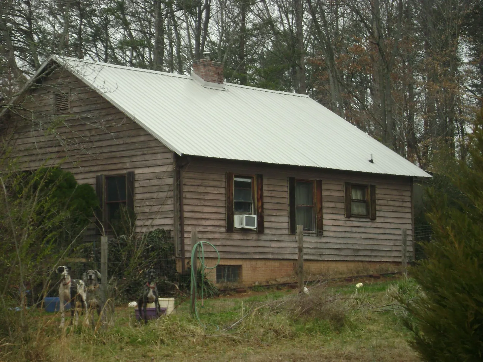 White metal roof on an old wood sided farmhouse, from a Metal Roof Installation job in Fountain Inn